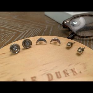 Three pairs of silver earrings.